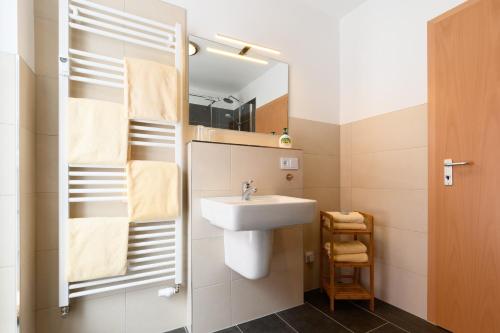 a bathroom with a sink and a mirror at Ferienwohnung Tannenblick 2-2 3-4 in Oberhof