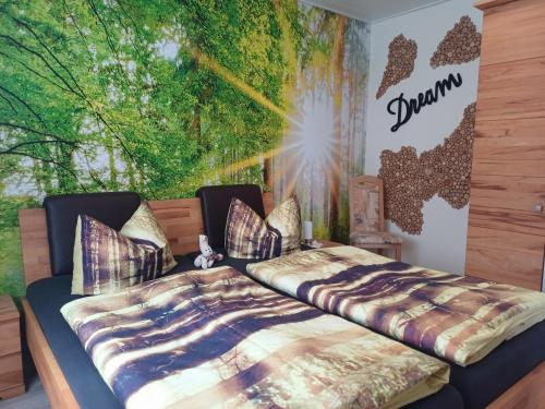a bedroom with two beds in front of a mural at Haus Nietmann_ Ferienwohnung 2 in Altenau