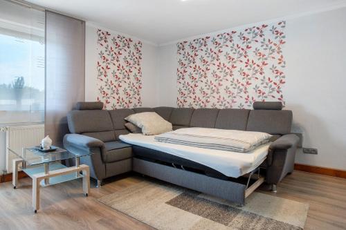 a living room with a couch and a table at Bungalow Bei Rügen in Sundhagen-Niederhof