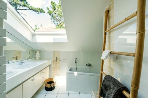 a bathroom with a sink and a skylight at Dune Lodge 2- Capbreton Hossegor - in Capbreton