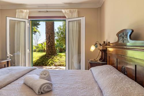 a bedroom with a bed and a large sliding glass door at Villa Echium T1 in Caniço