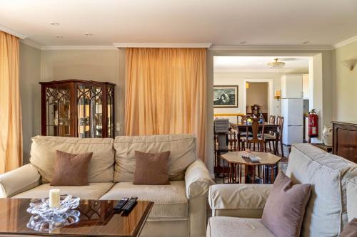a living room with a couch and a table at Villa Echium T1 in Caniço