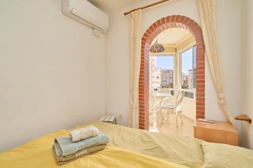 a bedroom with a bed in a room with a window at Sea Views Centro Internacional A99 in Torrox