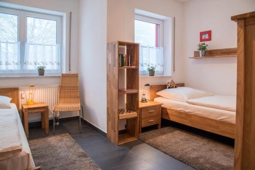 a bedroom with two beds and a book shelf at Ferienwohnung Tannenblick 2-2 3-4 in Oberhof