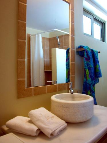 a bathroom with a sink and a mirror at Villa Kochilaki Ideales Resort in Kefallonia