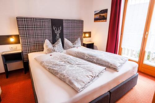 a bedroom with two beds with white pillows at Gästehaus Wolfgang Weitsee in Ruhpolding