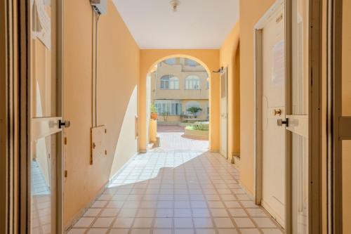 an empty hallway with an archway in a building at Studio Flat Blu Palermo Mondello in Palermo