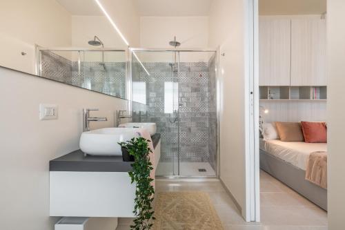 a bathroom with a sink and a shower at La Casa dei sognatori in Villasimius