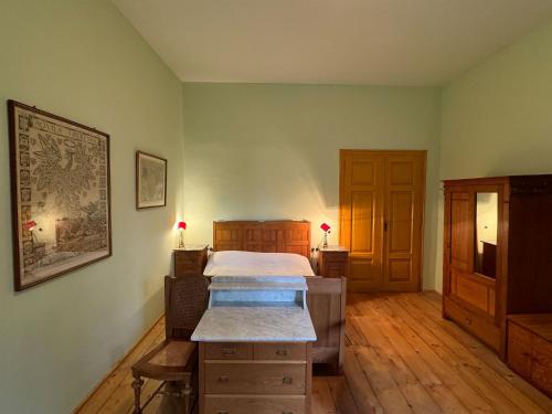 a bedroom with a bed and a wooden floor at Haus Tanegg in Innsbruck