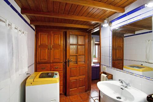 a bathroom with a sink and a toilet and a mirror at La Chirlaca in Tijarafe