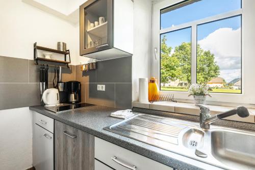 a kitchen with a sink and a window at Ferienhaus Rodershausen in Rodershausen