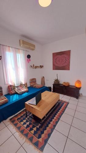a living room with a couch and a table at Syros Mandala Studios in Megas Gialos - Nites