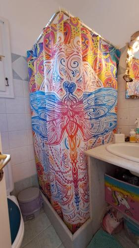 a colorful shower curtain in a bathroom with a sink at Syros Mandala Studios in Megas Gialos - Nites