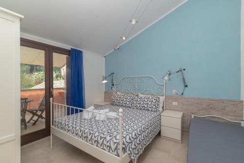 a bedroom with a bed and a balcony at C 306 Attico Puntavilla Mare in La Maddalena