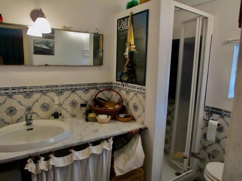 a bathroom with a sink and a shower at Antico Dammuso Invernale in Pantelleria