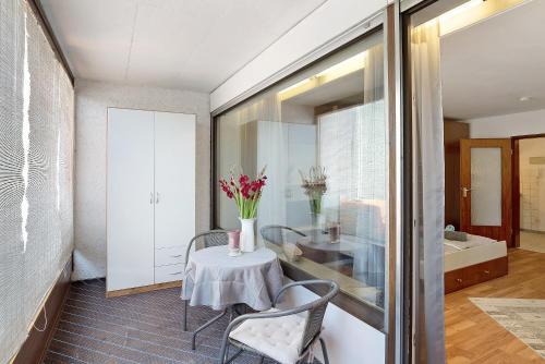a dining room with a table with flowers on it at Appartement Arend in Dobel