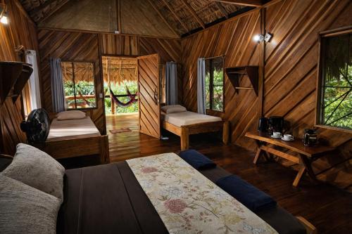 a bedroom with a bed and a desk in a room at Wildlife Lodge Cahuita in Cahuita