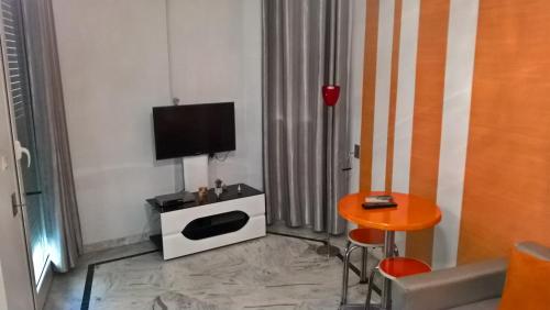 sala de estar con TV y mesa en Résidence Ghozlane en Túnez