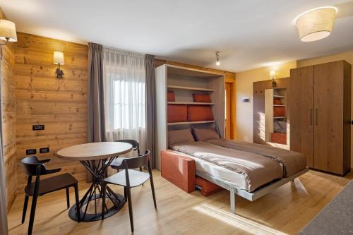 a bedroom with a bed and a table and chairs at Villa Elma - Livigno in Livigno
