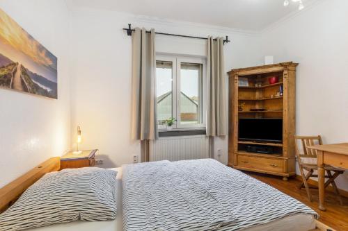 a bedroom with a large bed and a window at Apartment zur alten Post in Ulrichstein