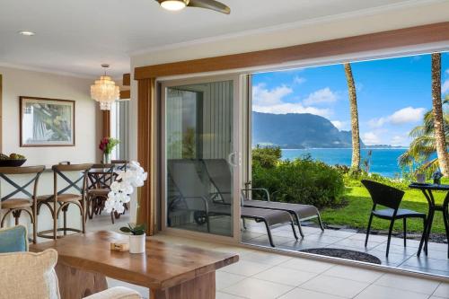 a living room with a large sliding glass door at Ocean Bluff Gem in Princeville Beach Access Pool in Princeville