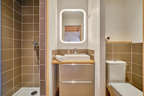 a small bathroom with a sink and a shower at Duplex Sauna privé Vénosc Le 1618 in Les Deux Alpes
