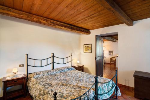 a bedroom with a bed and a wooden ceiling at Antico Granaio in Vessalico