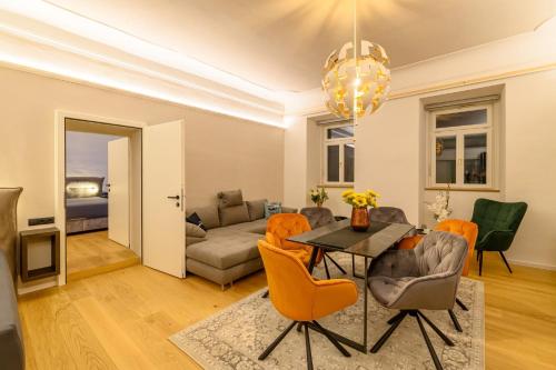 a living room with a table and chairs and a couch at Gh Alte Post - Top 4 Commodore in Gmünd in Kärnten