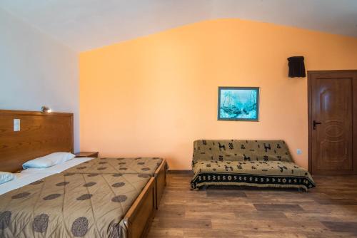 a bedroom with two beds and a chair in it at Mirage Arillas Honeymoon Studio in Arillas