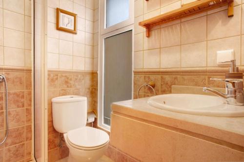 a bathroom with a toilet and a sink at Energia Dourada - Porto Santo in Porto Santo