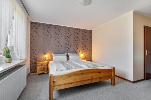 a bedroom with a wooden bed in a room at Ferienwohnung Sawade Schafstedt in Schafstedt