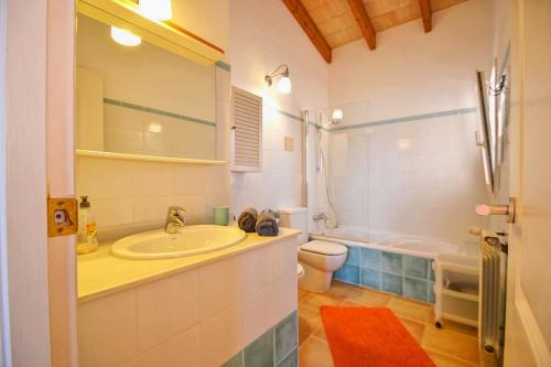 a bathroom with a sink and a shower and a toilet at Embat in Colonia de Sant Pere