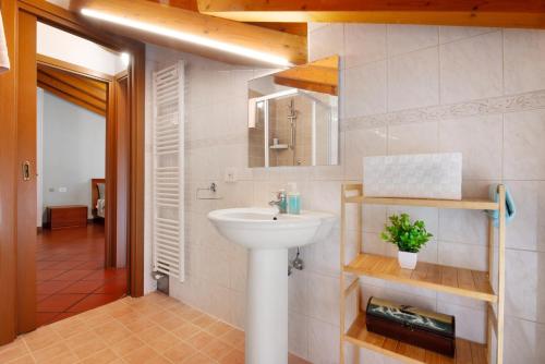 a bathroom with a sink and a mirror at La Corte Di Zio Pippo in Albavilla