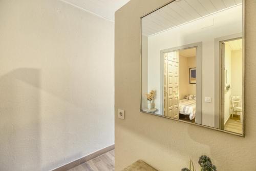 a mirror on a wall in a room at Apartamento Bajo 2 in Begur
