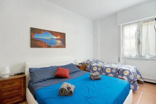 a bedroom with a bed and a couch and a window at Casa Dica in Rapallo