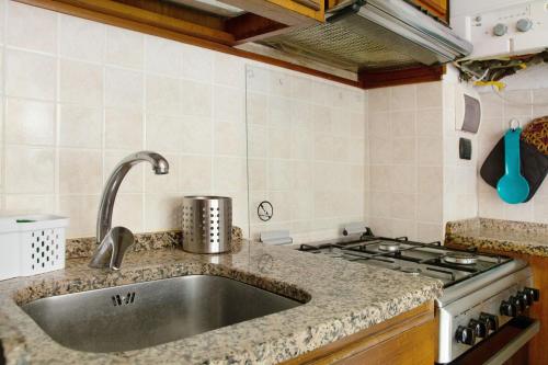 a kitchen with a sink and a stove at Casa Dica in Rapallo