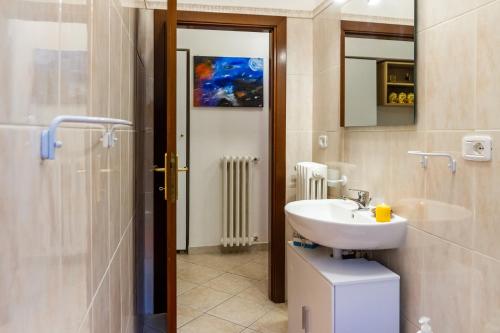 a bathroom with a sink and a toilet and a mirror at Appartamento Onda d'argento in Porto Santo Stefano