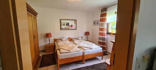 a small bedroom with a bed and a window at Ferienwohnung Zum Plauderbaum in Balve