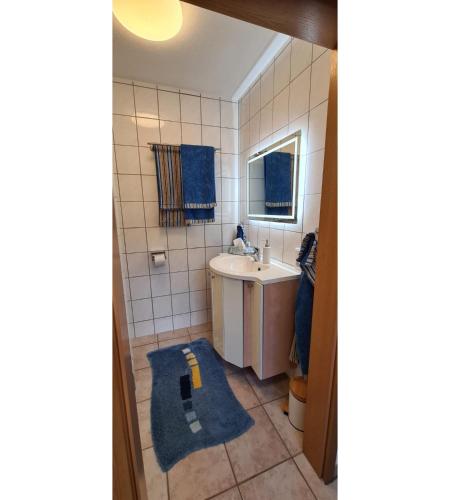 a small bathroom with a sink and a mirror at Ferienwohnung Zum Plauderbaum in Balve