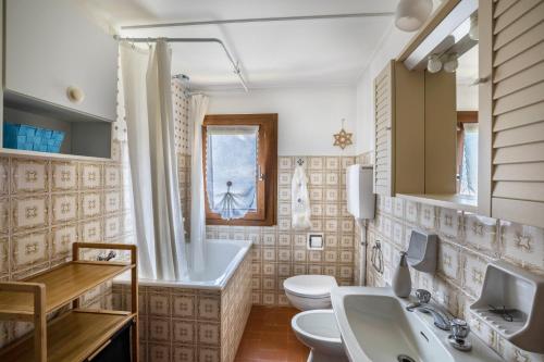 a bathroom with two sinks and two toilets at La Mansarda di Chiara e Silvio in Trasquera