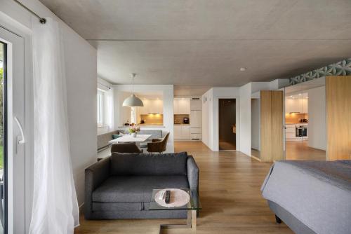 a bedroom with a bed and a couch and a table at Ferienwohnung Frieda in Frickingen