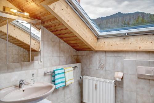 a bathroom with a sink and a large window at Ferienwohnung Frieder in Grainau