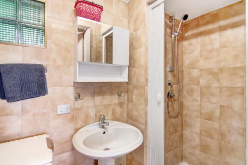 a bathroom with a sink and a shower at Gravedona Lake Como in Consiglio di Rumo