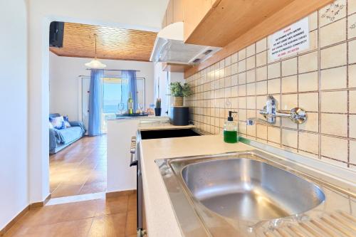 a kitchen with a sink and a counter top at Dolphin villa 1 in Gaios