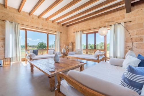 a living room with white furniture and large windows at Son Coranta in Campos