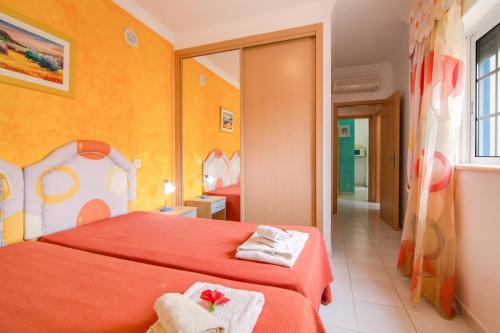a bedroom with a red bed with towels on it at Bosque São José Ag in Olhos de Água