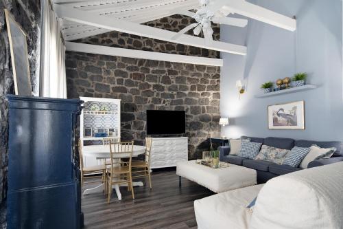 a living room with a couch and a table at Pico Boutique House in Lajes do Pico