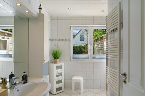 a bathroom with a sink and a shower at Haus Scheve in Rhauderfehn