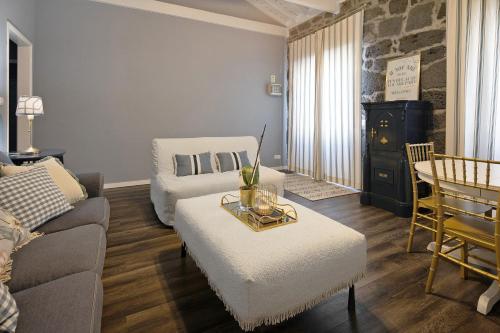 a living room with a couch and a table at Pico Boutique House in Lajes do Pico