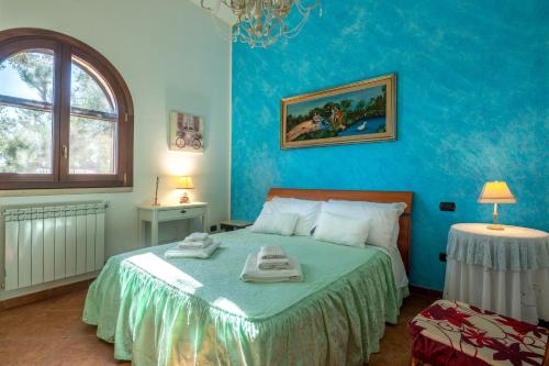 a bedroom with a bed with two towels on it at Tenuta del Normanno in Carovigno